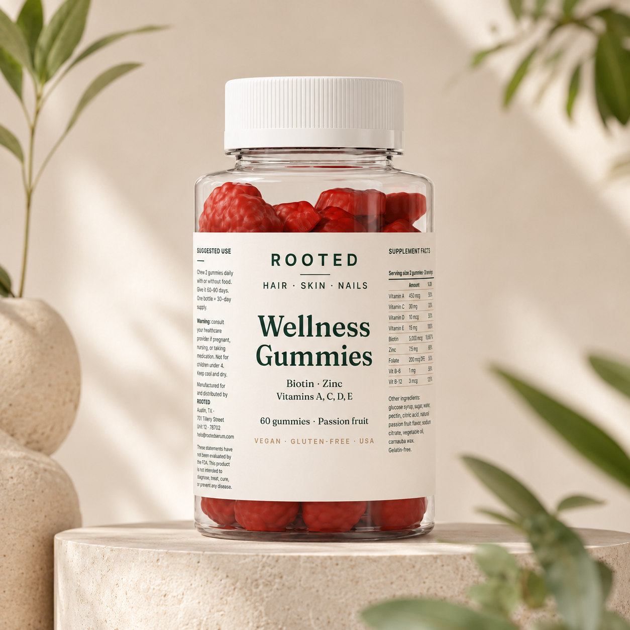 ROOTED Wellness Gummies bottle on a stone pedestal with a plant